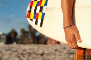 closeup of a surfer holding a surfboard